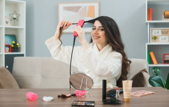 beauty-lifestyle smiling looking camera straighten hair with flat iron young girl sitting at table with makeup tools in living room SSUCv3H4sIAAAAAAAACpyRwW7DIAyG75P2DhHnRiIhStq9SrWDITRBpVAB6TRVffcZCBXn3fBn+7d/8/z8aBrCwStBvppnjDBWWm8+OAjKGsT0sHMnzSxdTR6OjbQGclbBOgW6hhyCWA3cJEKzaR3xKyWJDxA2L32cviMBQS6okeFbIq94znFTEimJHZgi5FAxv/HECsri/+rMj+/iBhZpxG9auDLipJaQjZxzKbn+BOlutTXYZmUrVw8rQMcCVindnRLKLFWbDWs6e2kTdjPBxRXemxNt7R24jie+oKYsfAXvsXwuvBok8JPtrZpjbEgGdlUy40/EsGP9yI4nemKsG+h0PHZ7Qf69VaFOWqcIYSyuaq6tq7gBAT5MU88v7ciHsR0mOrRAh1MLEiij3Tj2YsLDv/4AAAD//wMAQWdDlZgCAAA=