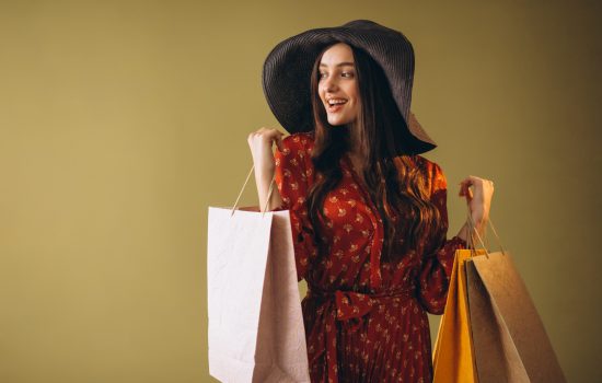 Young woman with shopping bags in a beautiful dress and hat Young woman with shopping bags in a beautiful dress and hat